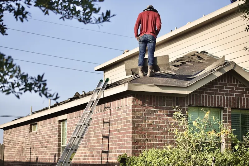 Professional roofer working on a residential roof in Weedonville